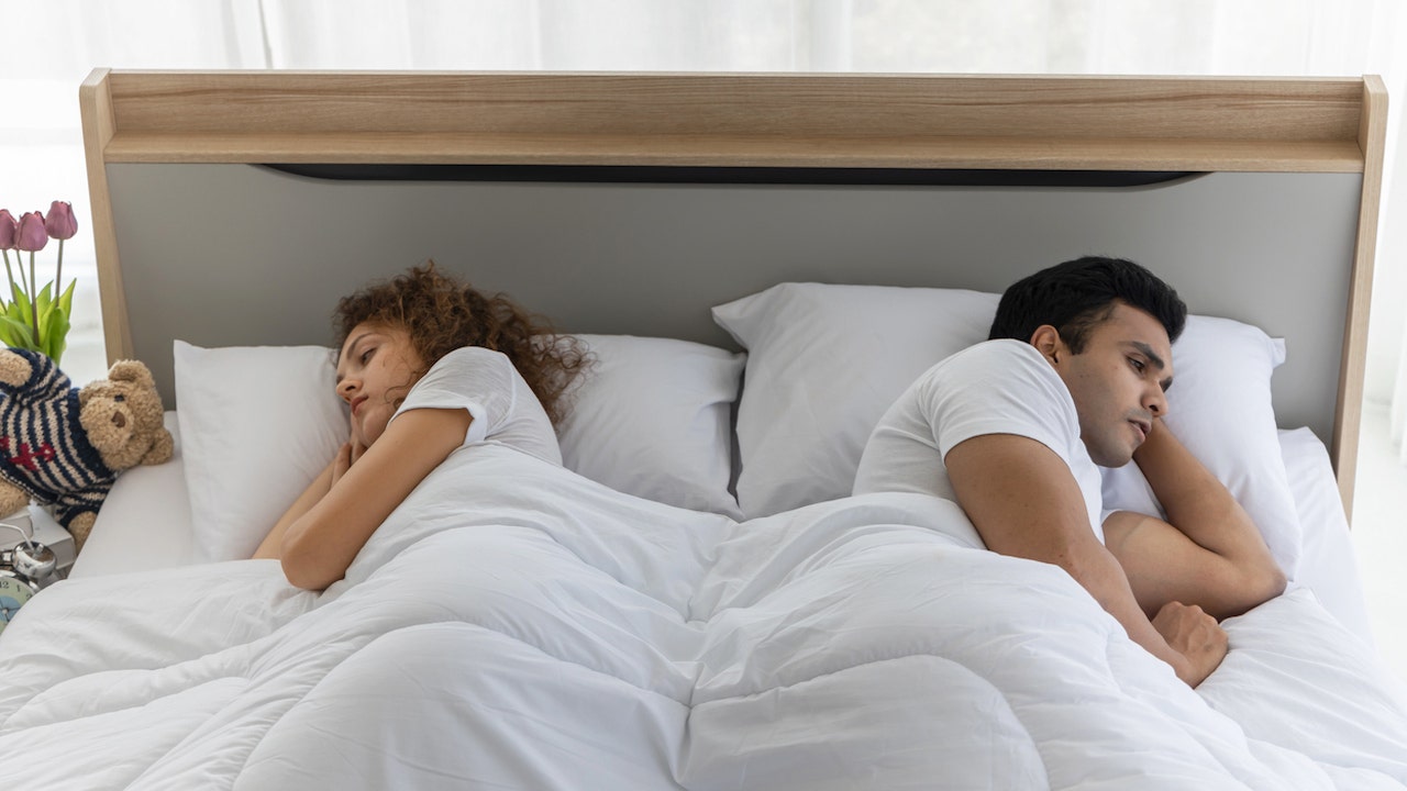 https://static.foxnews.com/foxnews.com/content/uploads/2023/11/couple-sleeping-apart.jpg