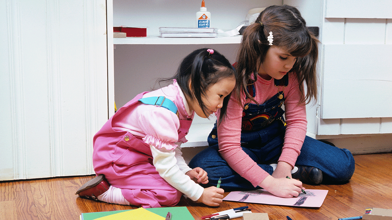 Two children coloring