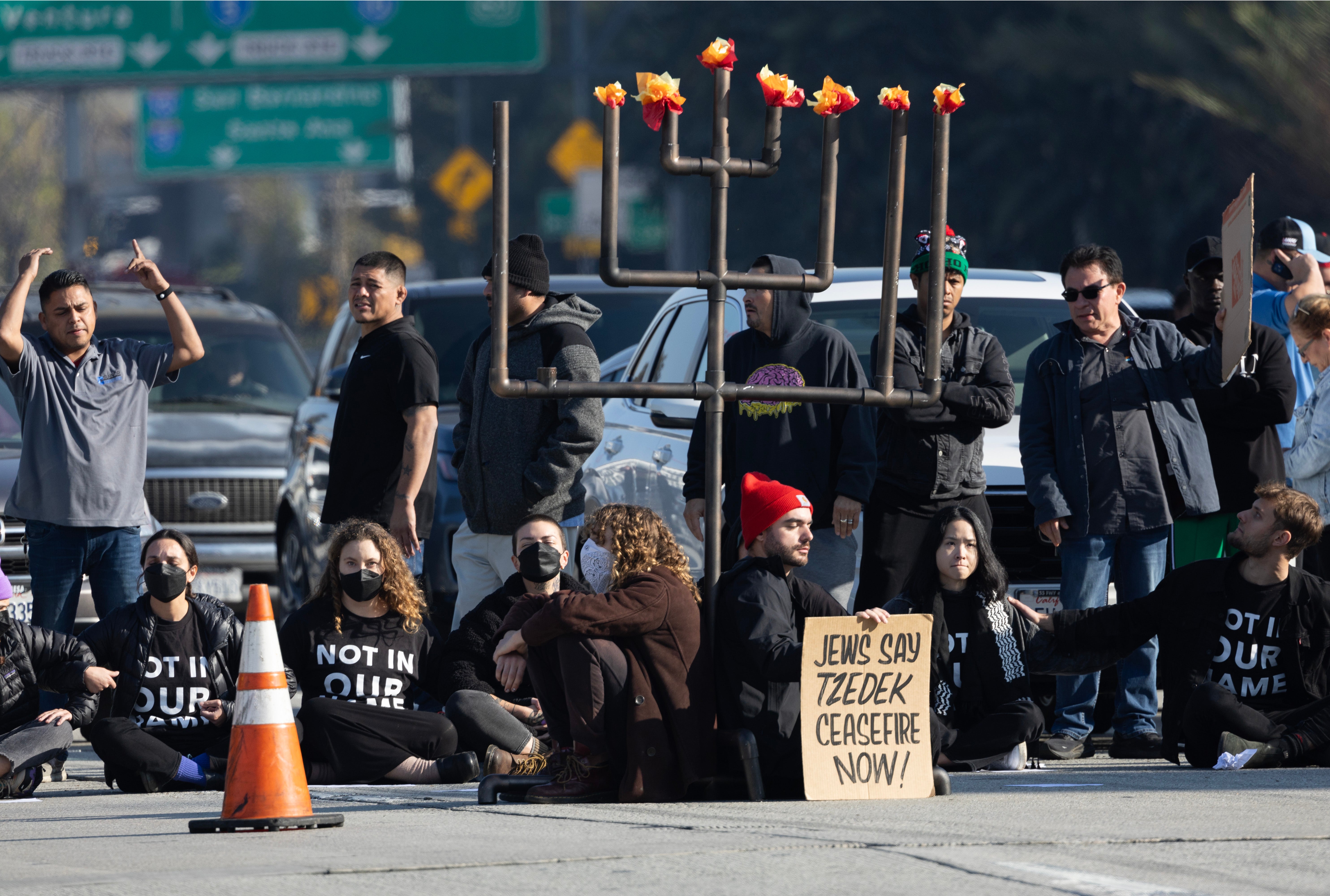 Angry commuters confront pro-Palestinian protesters blocking LA freeway during rush hour