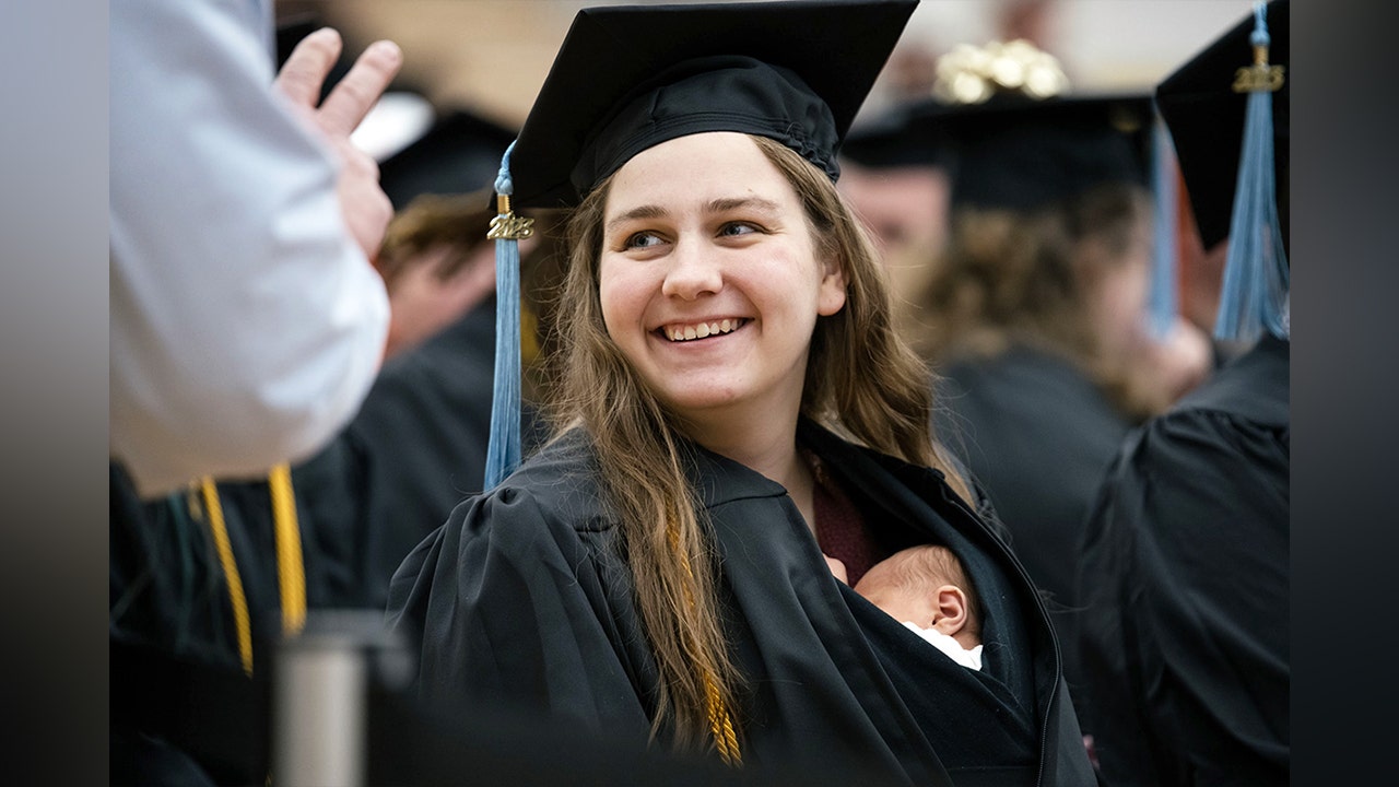 Michigan woman walks stage at college graduation with 10-day-old daughter inside gown