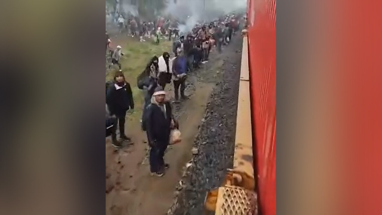 Thousands of migrants wait a few hours south of Eagle Pass, Texas, to catch trains headed for southern border