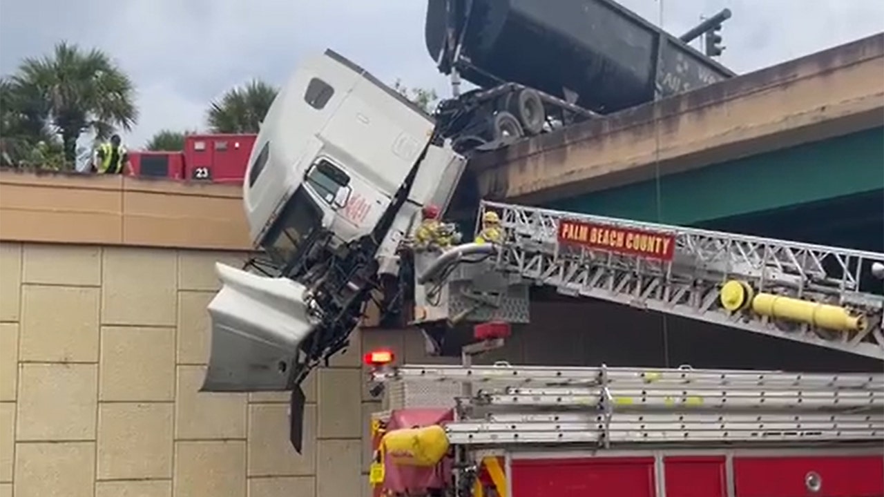 Video shows incredible rescue of driver trapped in semi-truck dangling from bridge