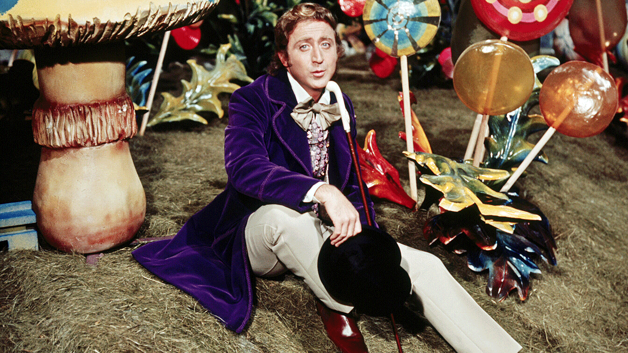 Willy Wonka star Gene Wilder sits in chocolate factory.