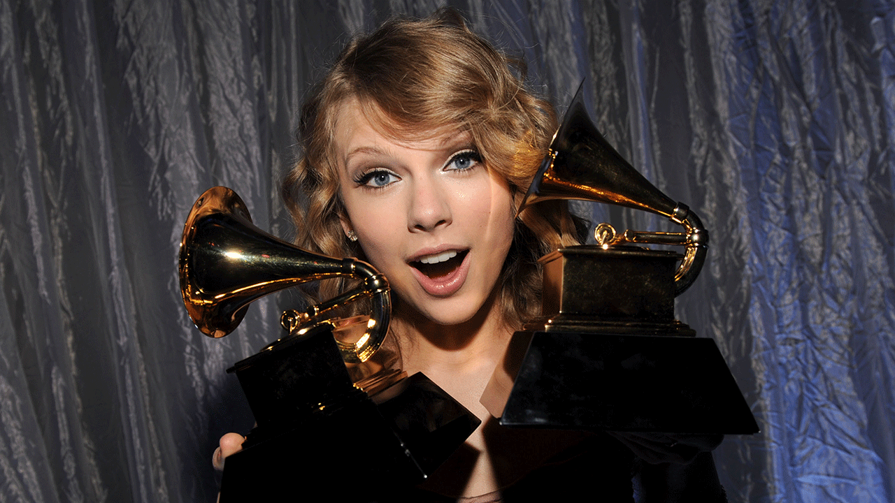 Taylor Swift holding Grammys 