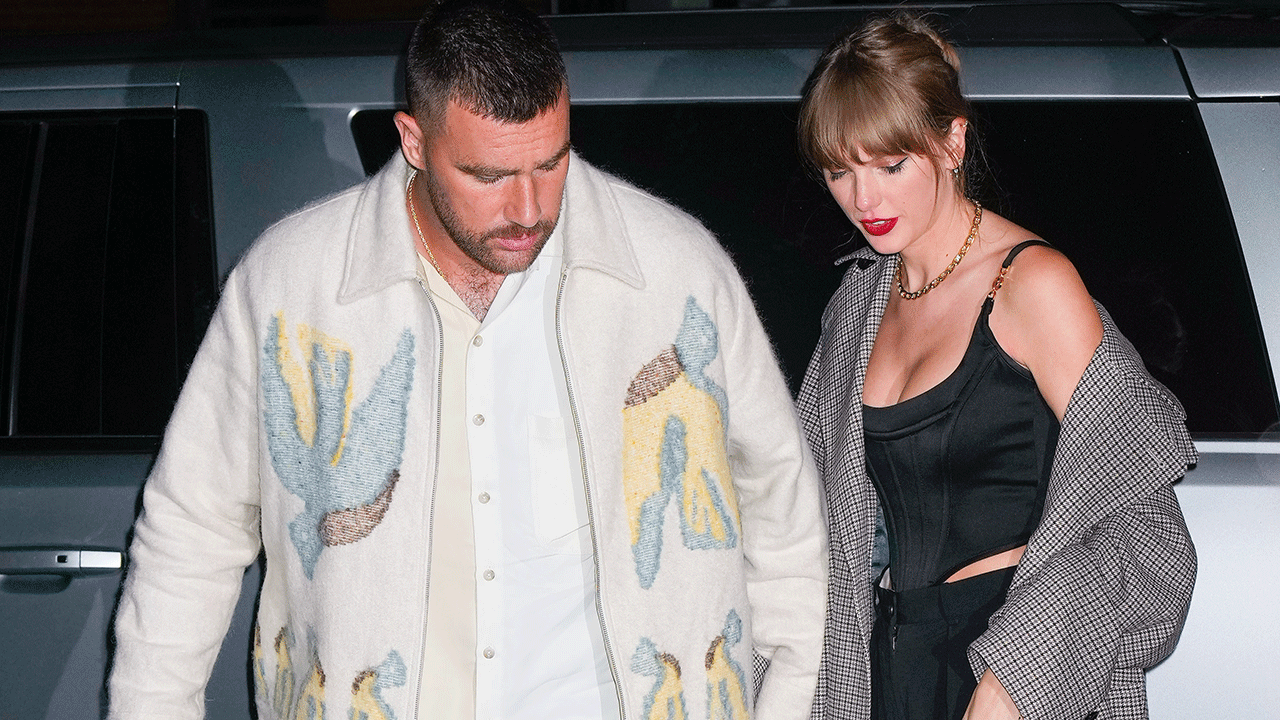Taylor Swift holding hands with Travis Kelce