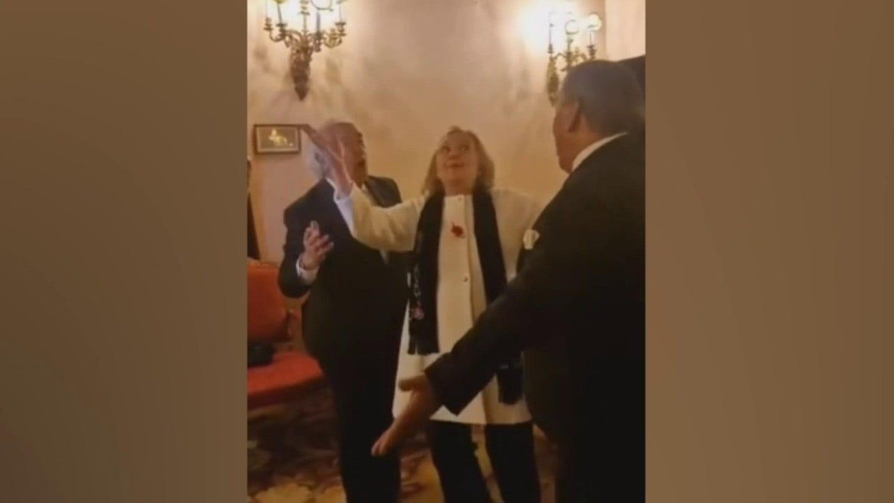 Hillary Clinton attempts 'La Macarena' dance with the band during a party in Spain