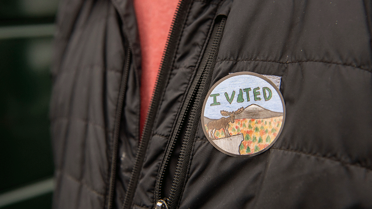 New Hampshire voter wears "I Voted" sticker on jacket