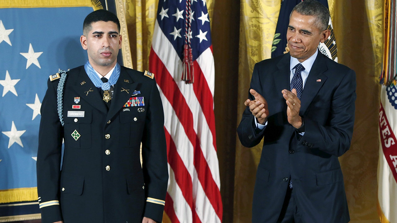 U.S. President Barack Obama applauds Medal of Honor recipient retired U.S. Army Captain Florent 