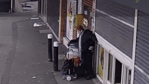 WATCH: Elderly woman keeps calm as store shutter accidentally lifts her off the ground