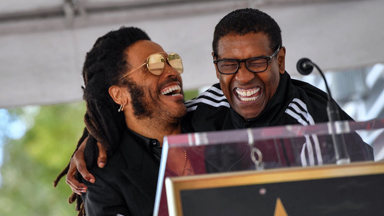 Lenny Kravitz and Denzel Washington laughing