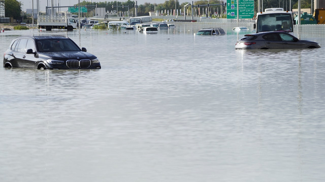 A storm dumps record rain across the desert nation of UAE and floods Dubai’s airport