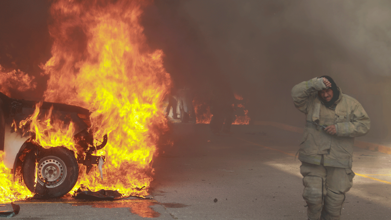 Protesters in southern Mexico set state government building afire and torch a dozen vehicles
