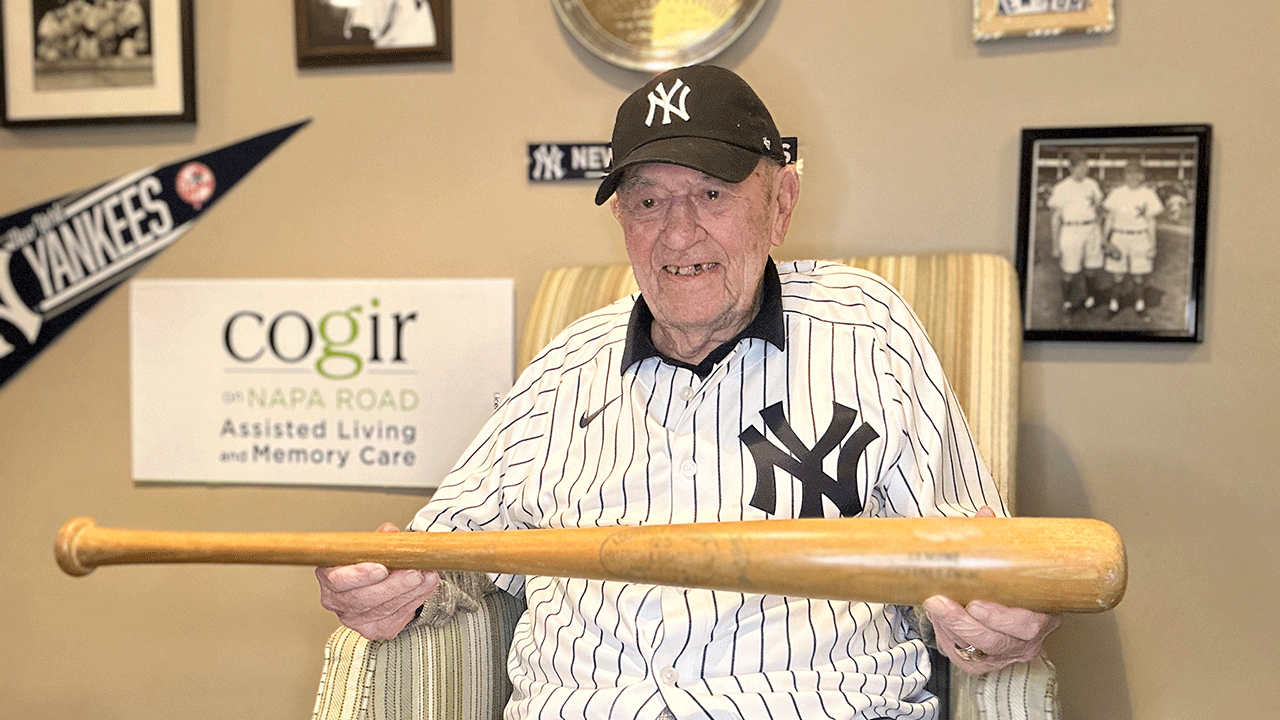 Art Schallock, the oldest living MLB player holding a baseball bat