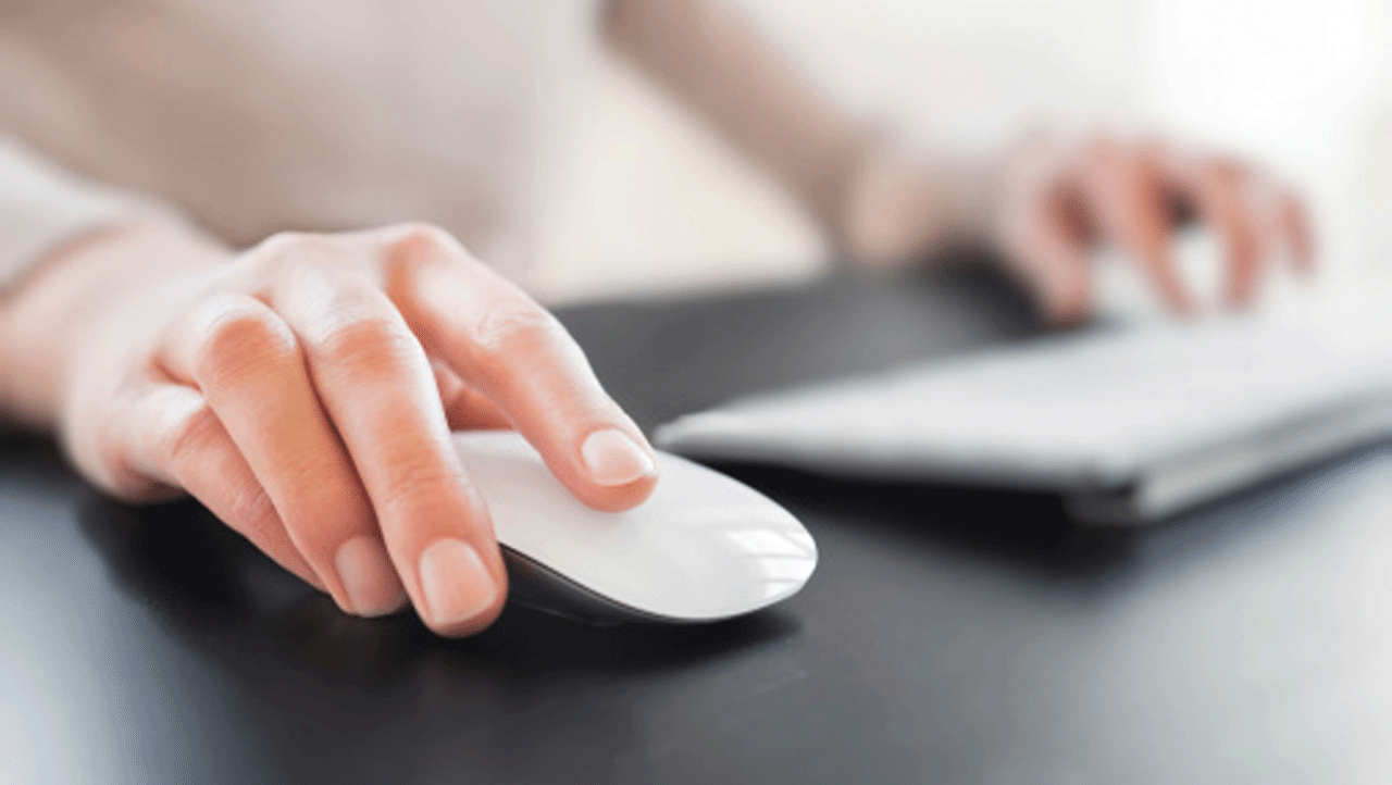 Female hand on computer mouse and keyboard