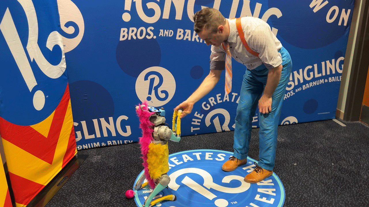 Ringling Bros. circus performer does balancing act with juggling, comedy, rola bola and a robotic dog