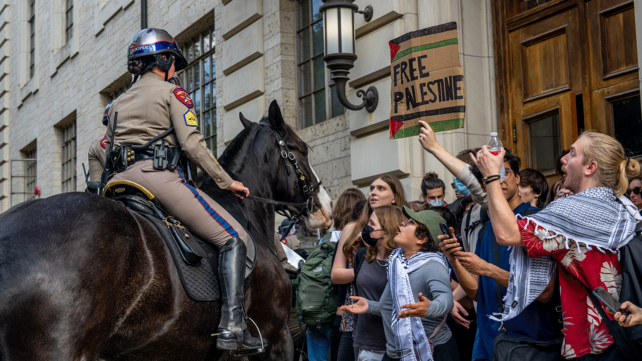 Officer connected horseback confronts protestors