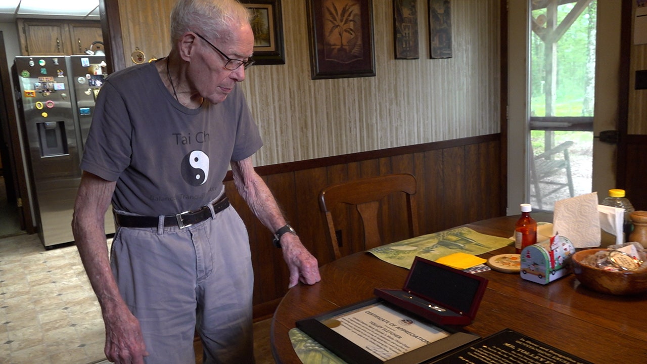 Tolley Fletcher looks at his honors given to him for his service in WWII