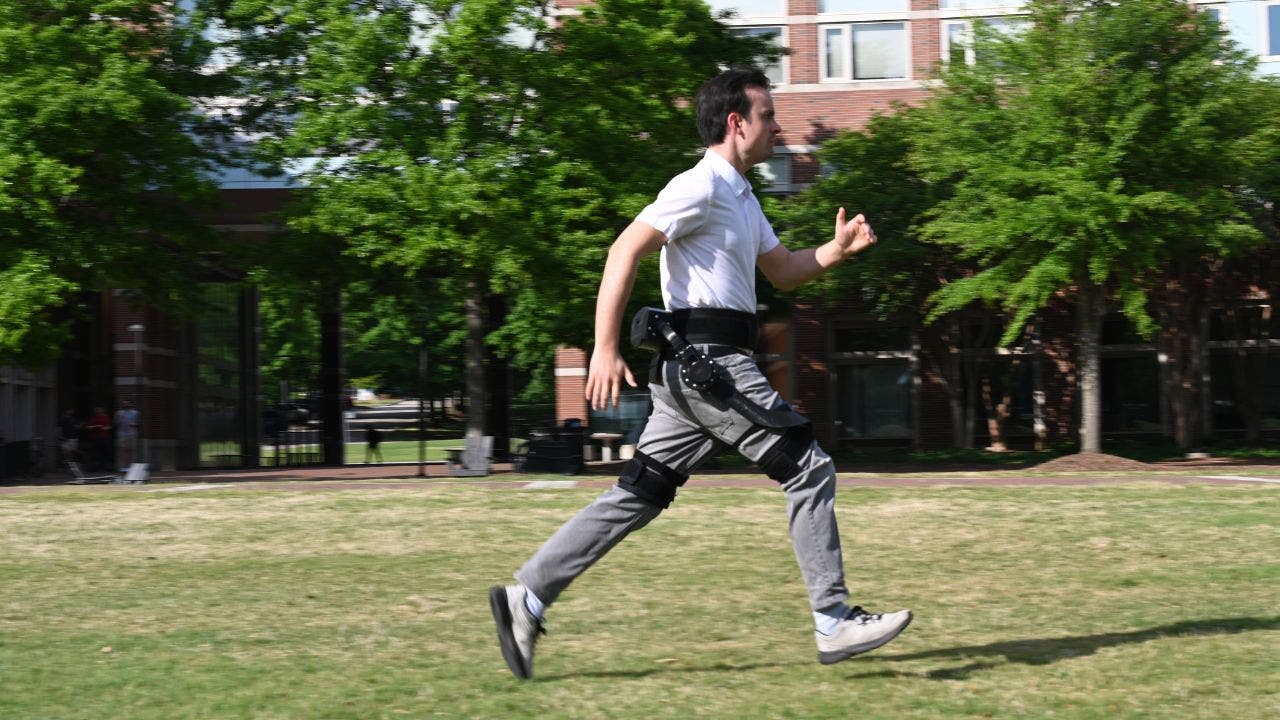 A man running while wearing an AI-powered exoskeleton. (Kurt 
