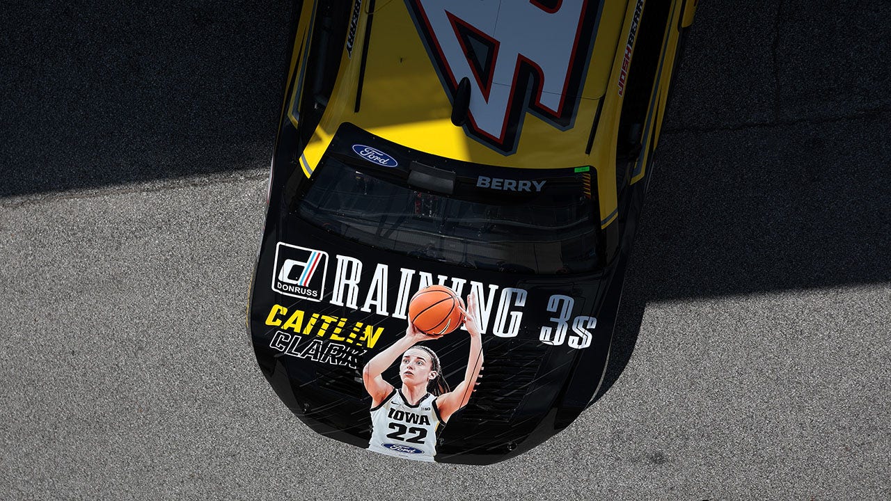 Caitlin Clark reacts to her image on hood of NASCAR’s Josh Berry’s vehicle