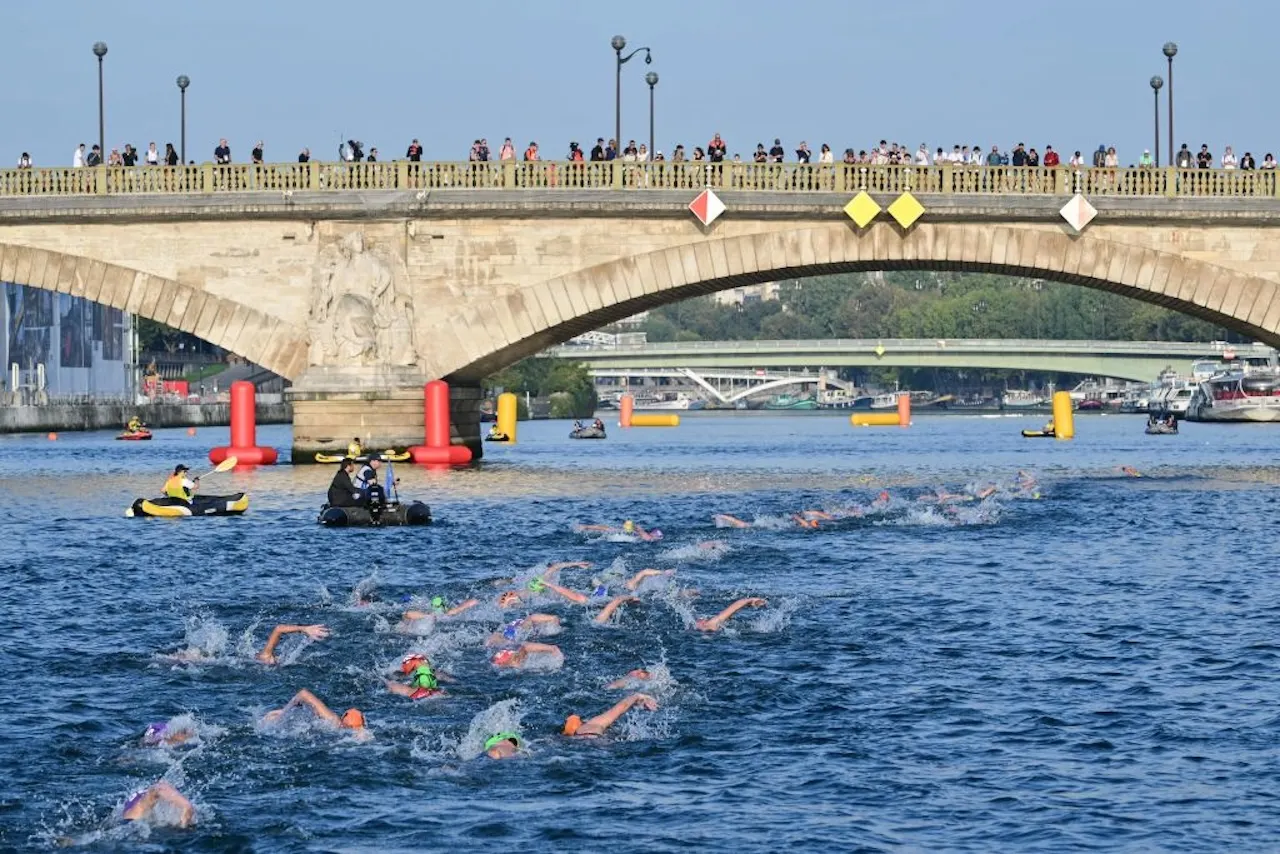 Triathlon athletes compete and swim in the Seine River during a test event for the women's triathlon for the upcoming 2024 Olympic Games in Paris. Click below to get experts' take on concerns about the river's water quality. (Getty Images)