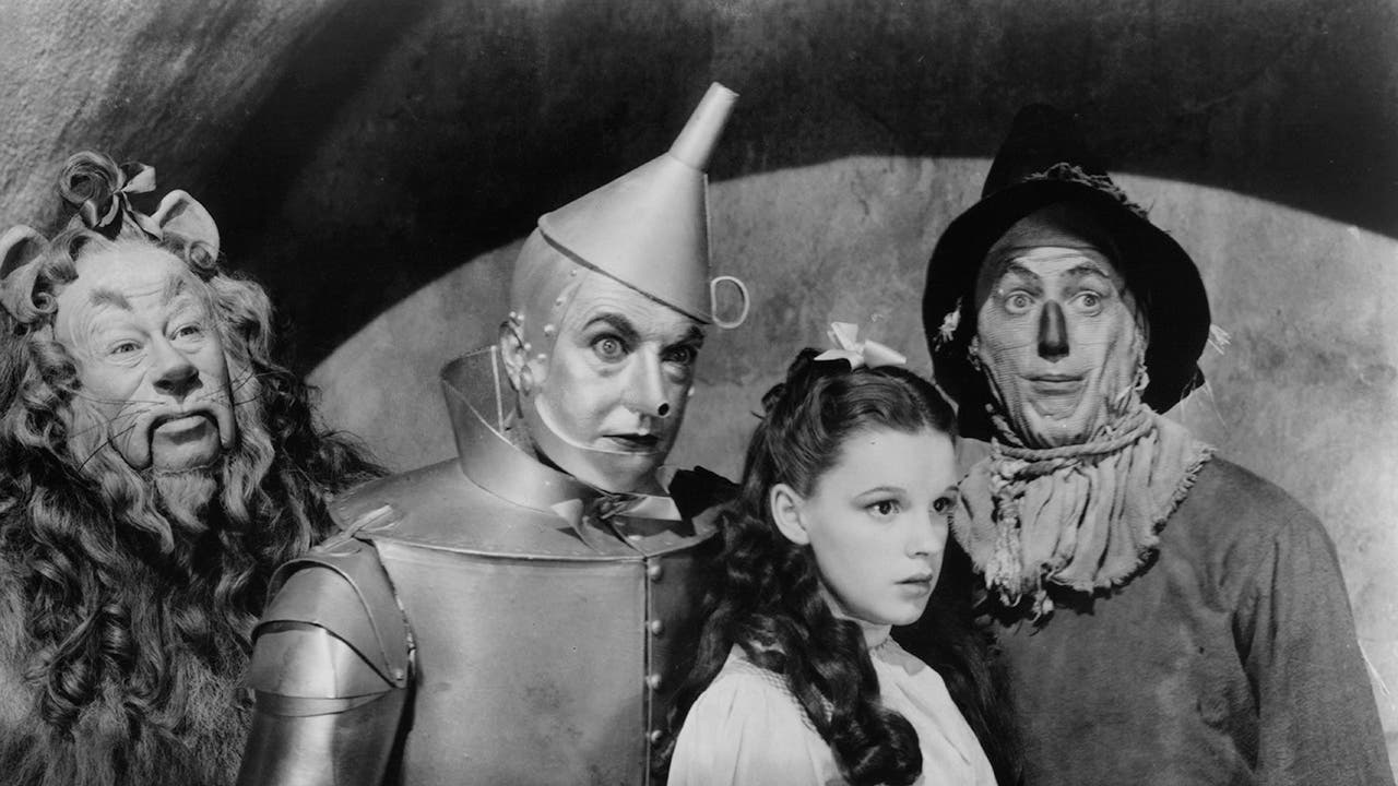 Bert Lahr as the Cowardly Lion, Jack Haley as the Tin Man, Judy Garland as Dorothy Gale and Ray Bolger as the Scarecrow in a scene from the film 