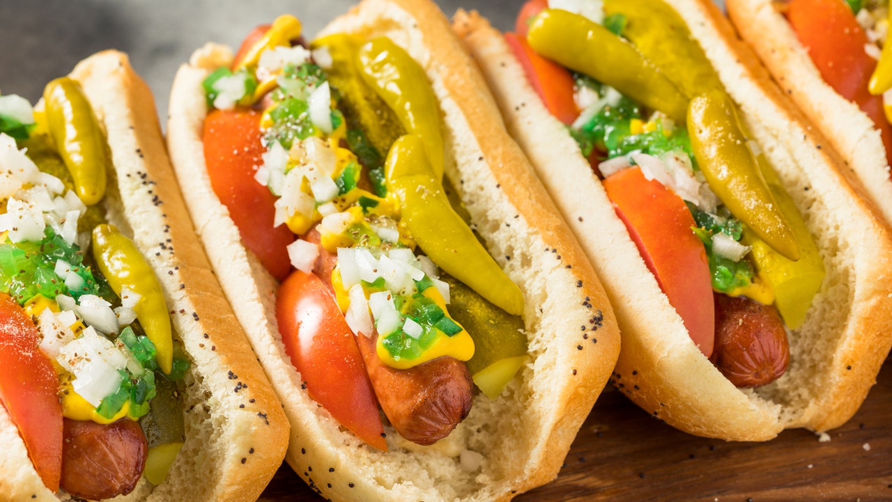 These homemade Chicago-style hot dogs are served with tomatoes, onions and peppers. (iStock)