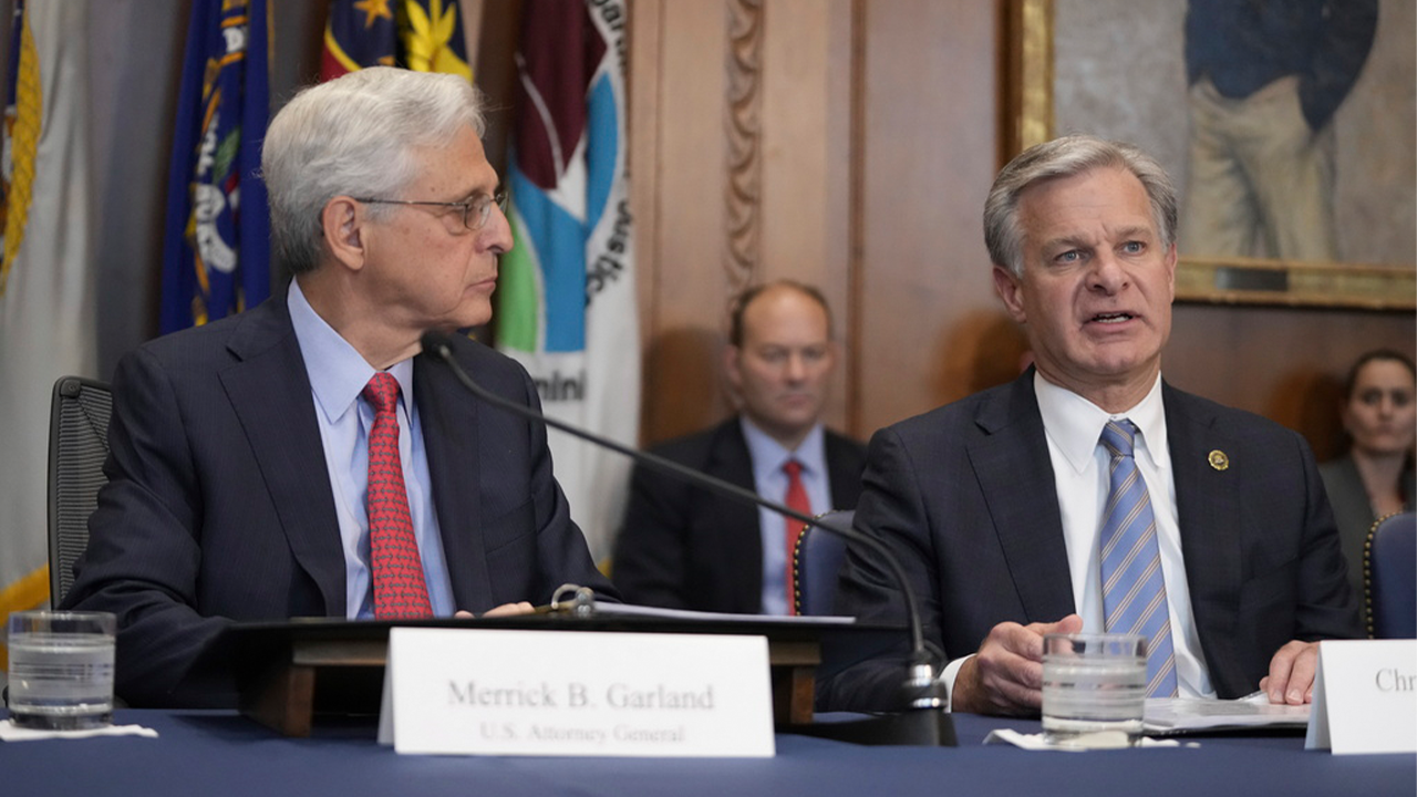 FBI Director Christopher Wray, right, speaks during a meeting of the Justice Department's Election Threats Task Force at the Department of Justice, on Wednesday, Sept. 4, 2024, in Washington, as Attorney General Merrick Garland, left, looks on. (AP Photo/Mark Schiefelbein)