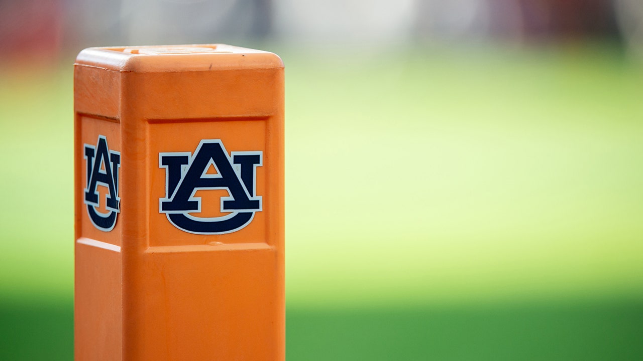 Auburn cheeleader knocks down Oklahoma player running onto field while performing stunts