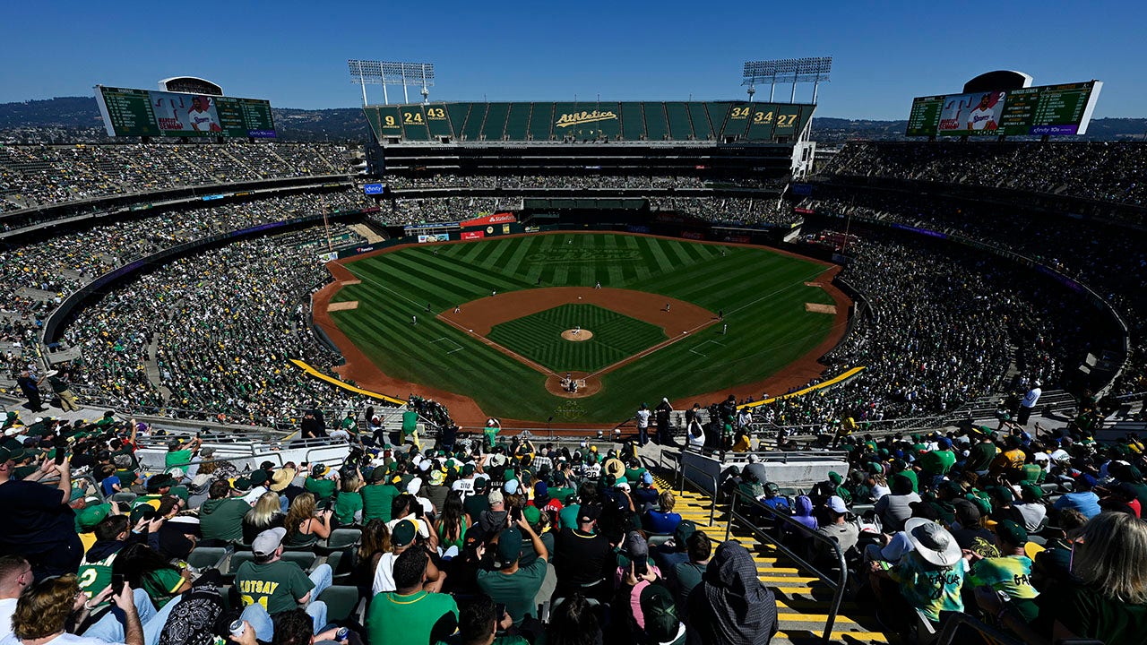 Fans throw objects and storm the field during the final A’s game in Oakland