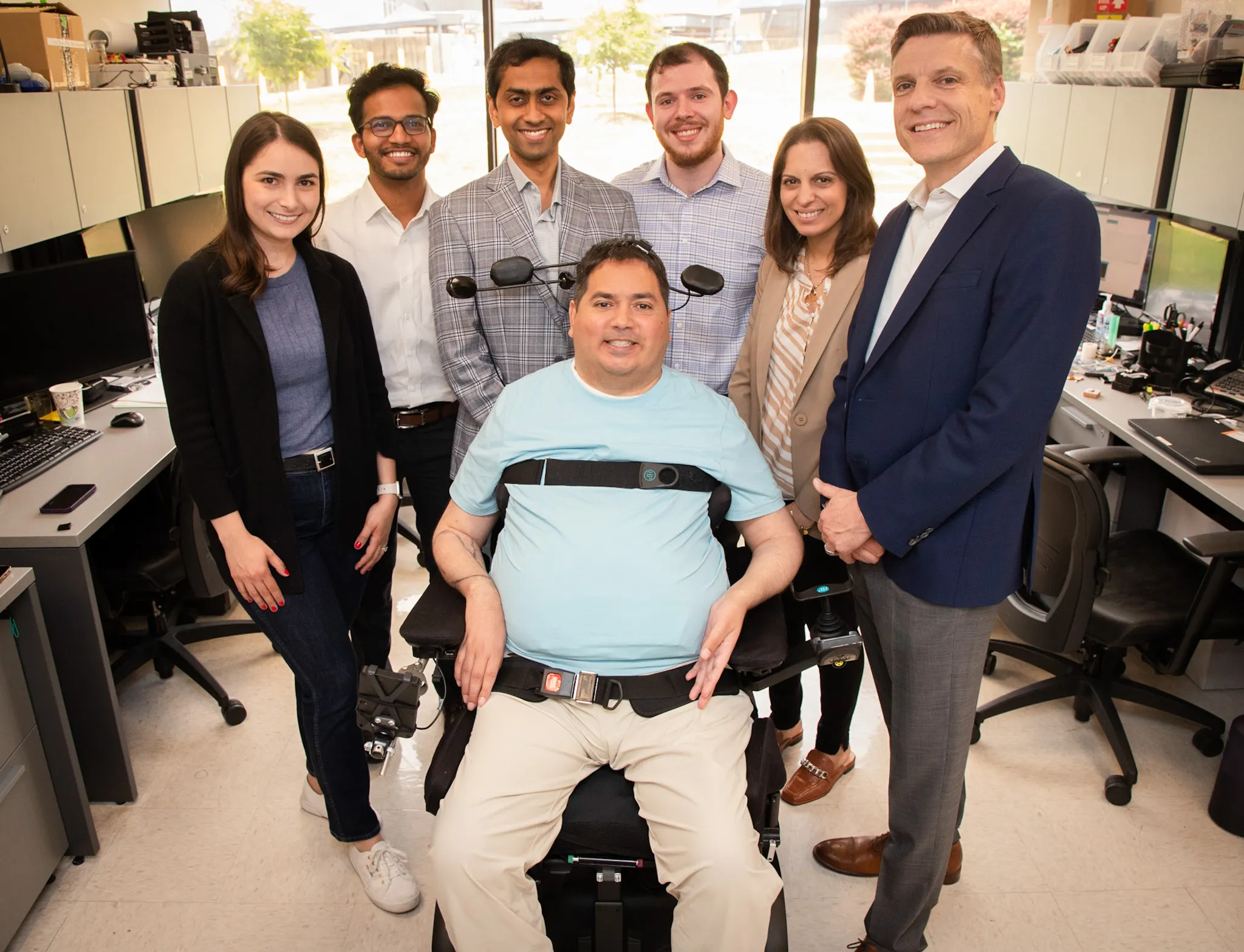 Keith Thomas, who lives with paralysis, poses with the research team at Northwell Health's Feinstein Institutes for Medical Research that worked with him for months to restore lasting movement and feeling in his arm and hand. The first-of-its-kind 'double neural bypass' system uses brain implants and artificial intelligence to allow signals to and from Thomas' brain to bypass the site of his injury. (Northwell Health's The Feinstein Institutes for Medical Research)