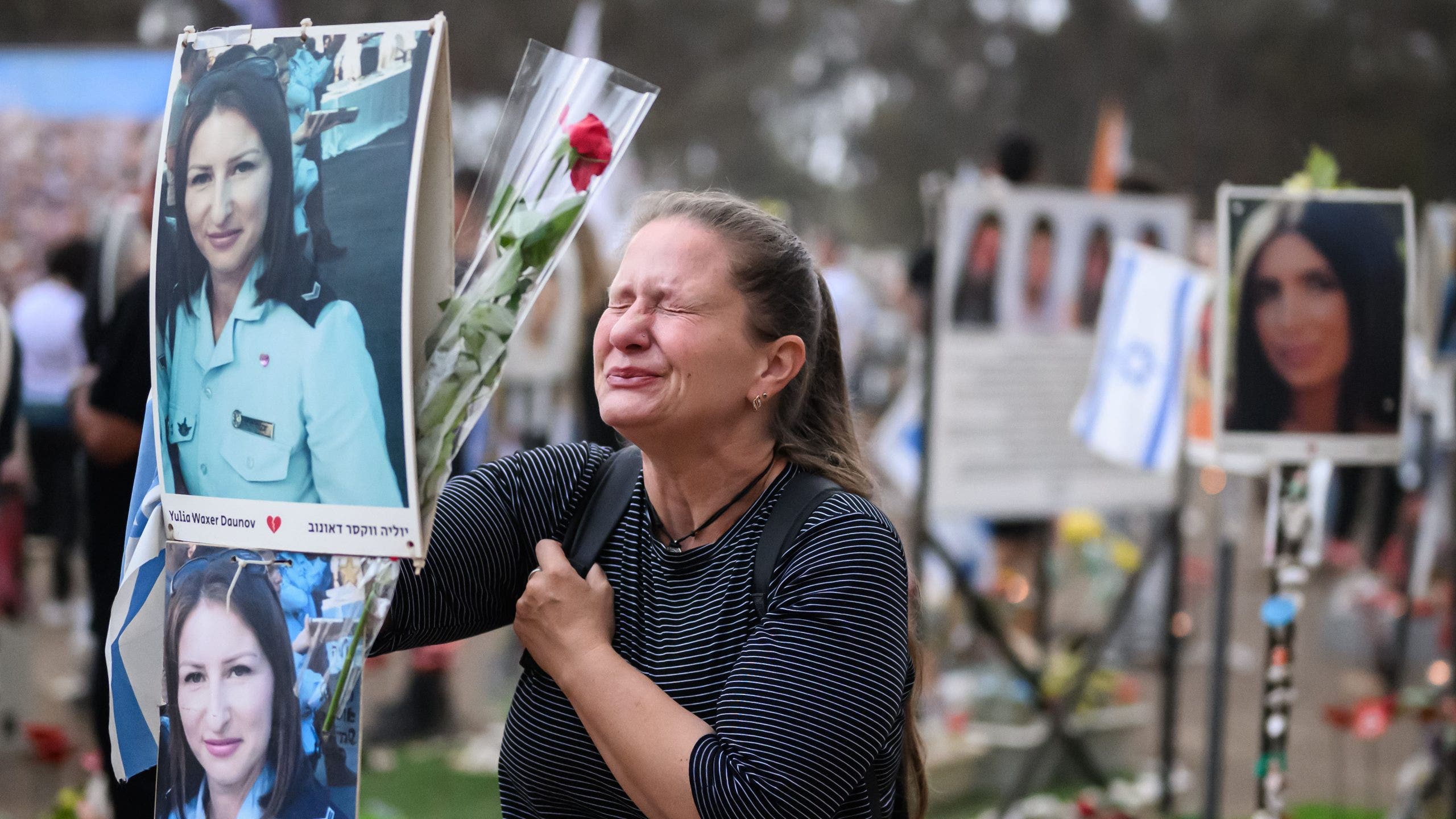 RE'IM, ISRAEL - OCTOBER 07: A woman breaks down at the memorial to Yulia Waxer Daunov as family members and friends of the lost and kidnapped gather at the site of the Nova Festival to mark the one year anniversary of the attacks by Hamas terrorists on October 07, 2024 in Re'im, Israel. (Leon Neal/Getty Images)