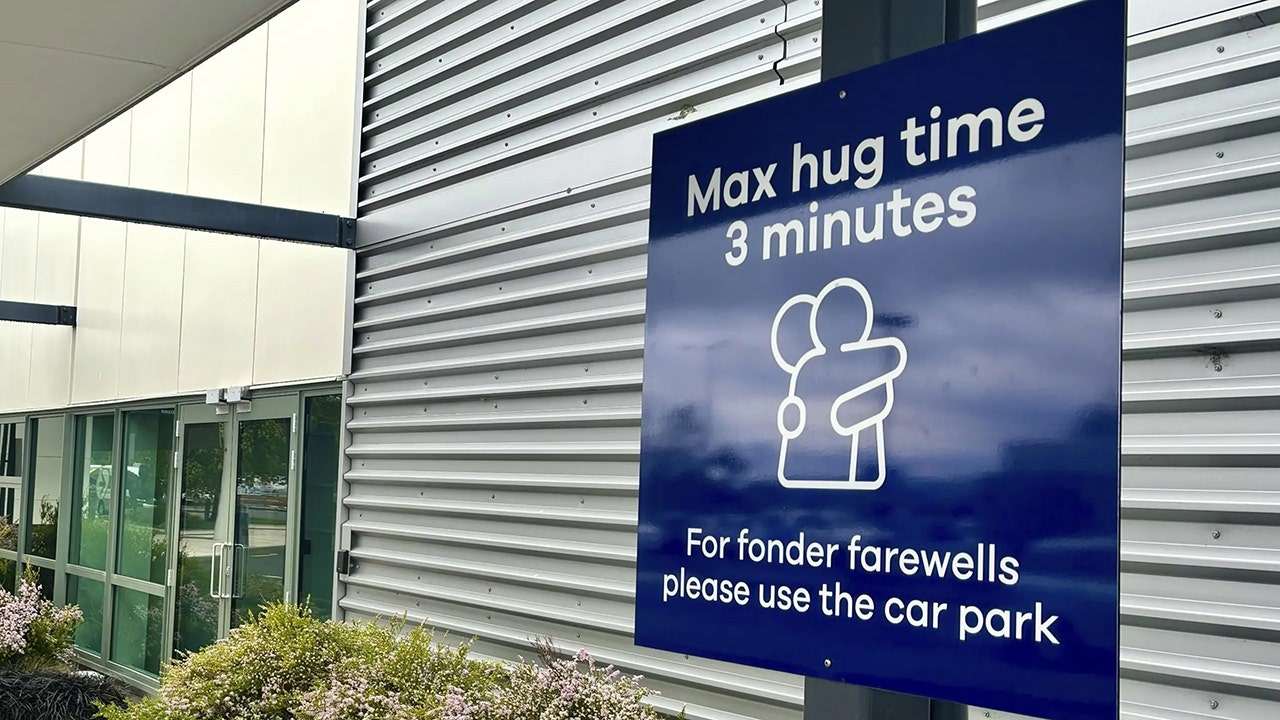 An airport overseas has implemented a new policy limiting the time on goodbye hugs. Some users took to social media to react. (Sarah Soper/Dunedin Airport via AP)