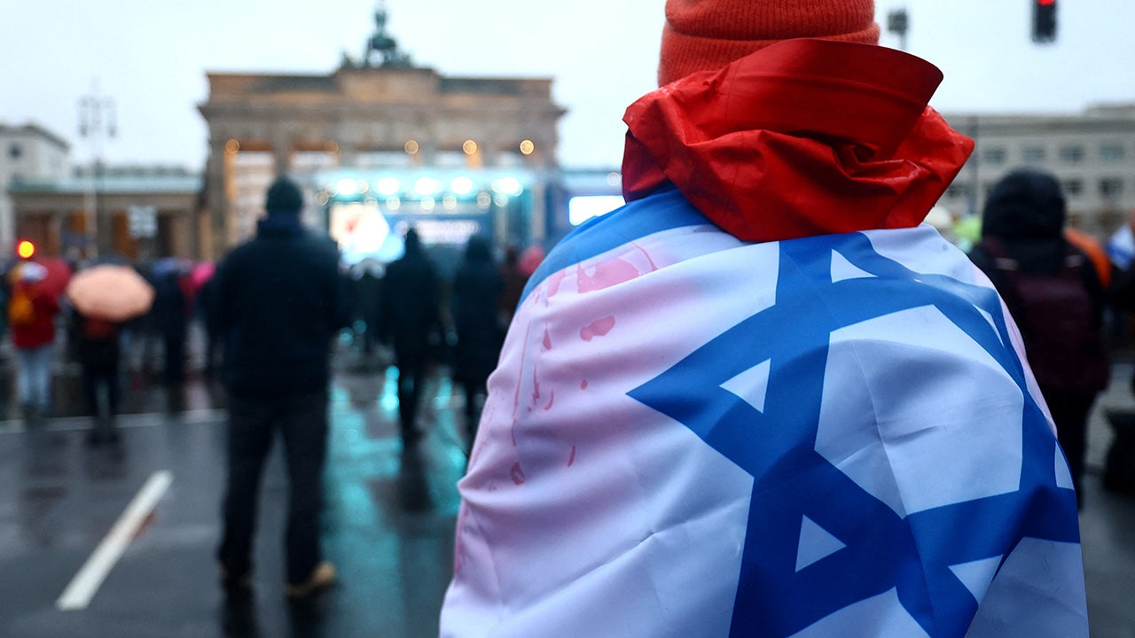 A person carries an Israeli flag during a protest against antisemitism at the Brandenburg Gate, amid the ongoing conflict between Israel and Palestinian Islamist group Hamas, in Berlin, Germany. REUTERS/Lisi Niesner (REUTERS/Lisi Niesner)