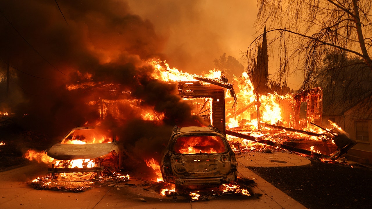 Vehicles and a house burn as powerful winds fueling devastating wildfires in the Los Angeles area force people to evacuate, at the Eaton Fire in Altadena, California, U.S. January 8, 2025. (REUTERS/David Swanson)