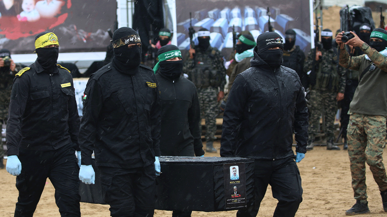 Hamas members carrying coffins