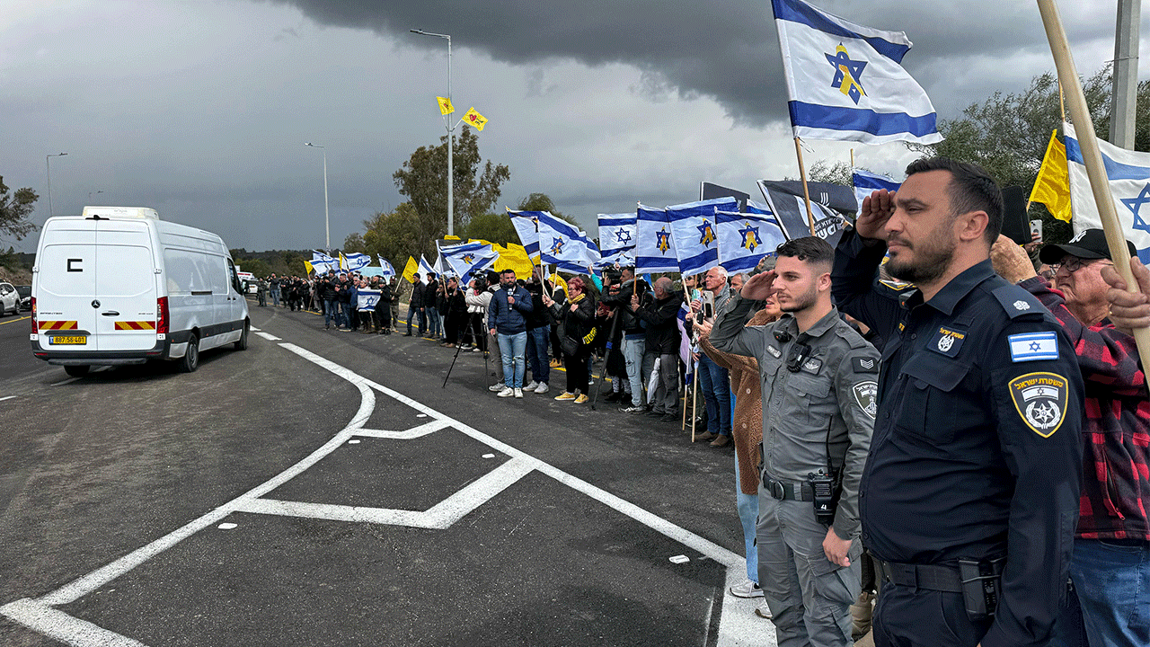 Israelis line road for convoy carrying bodies of slain hostages