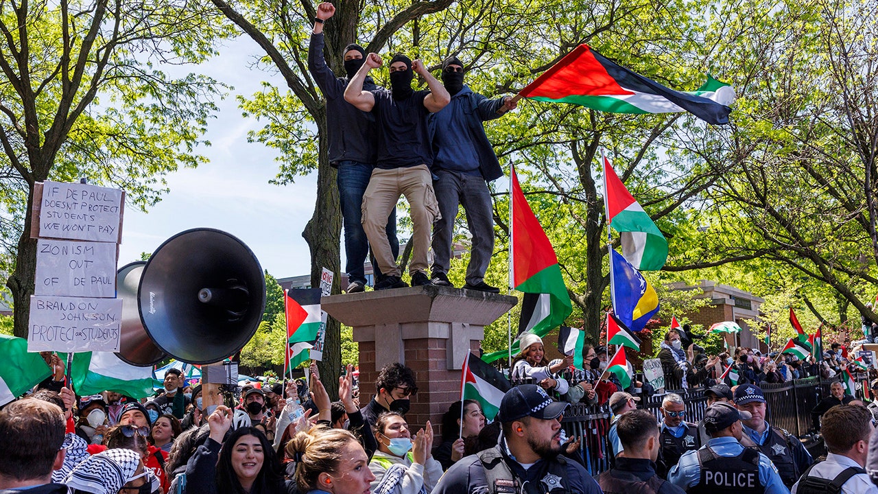 Pro-Palestinian activists argue with pro-Israel activists while members of the Chicago Police department stand between the two groups outside a pro-Palestinian encampment at DePaul University on Sunday, May 5, 2024, in Chicago, Ill. (Armando L. Sanchez/Chicago Tribune/Tribune News Service via Getty Images)