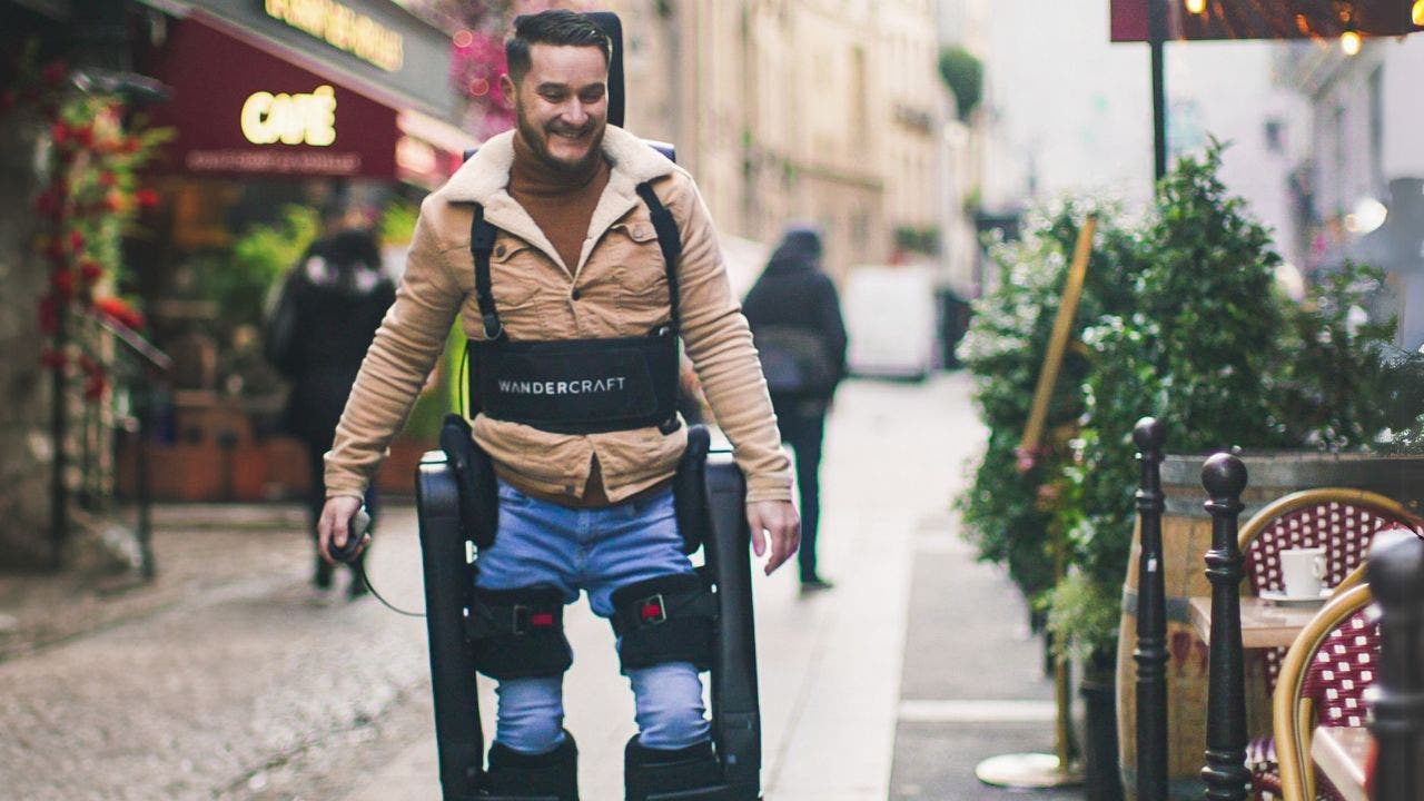 A man using an exoskeleton to walk. (Wandercraft)