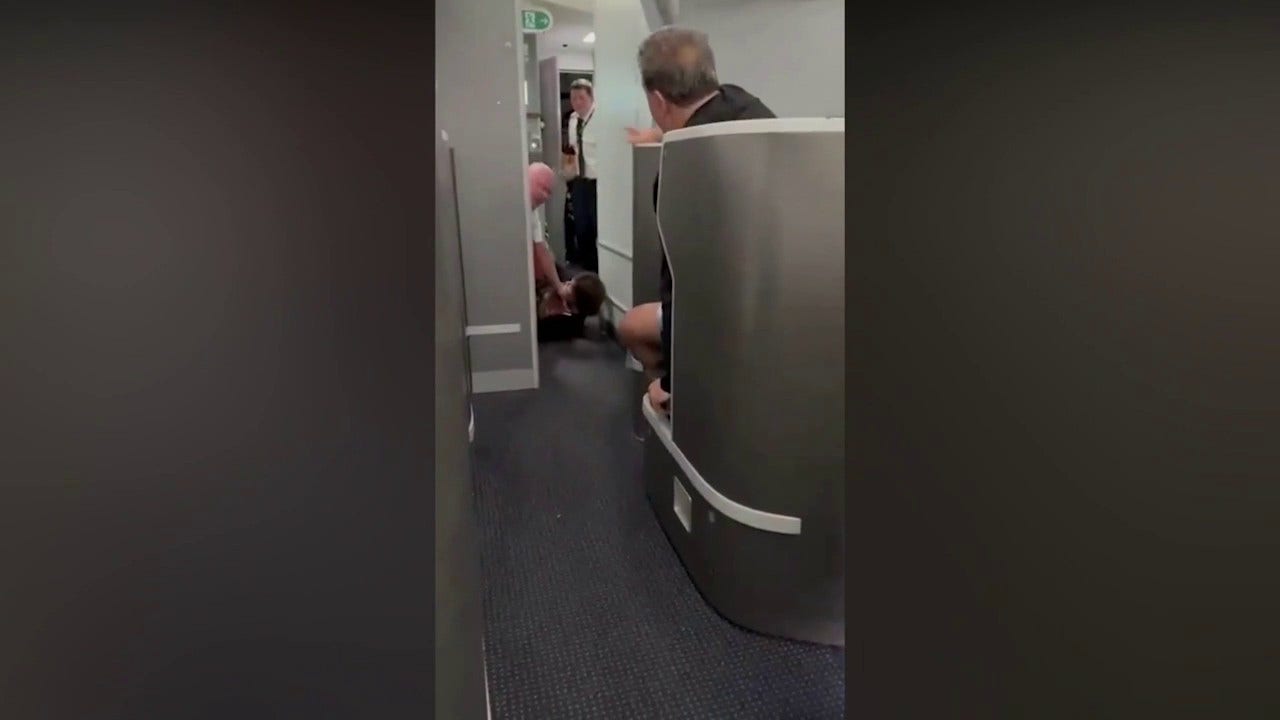 American Airlines passenger restrained, knocked to floor while barging into cockpit: video