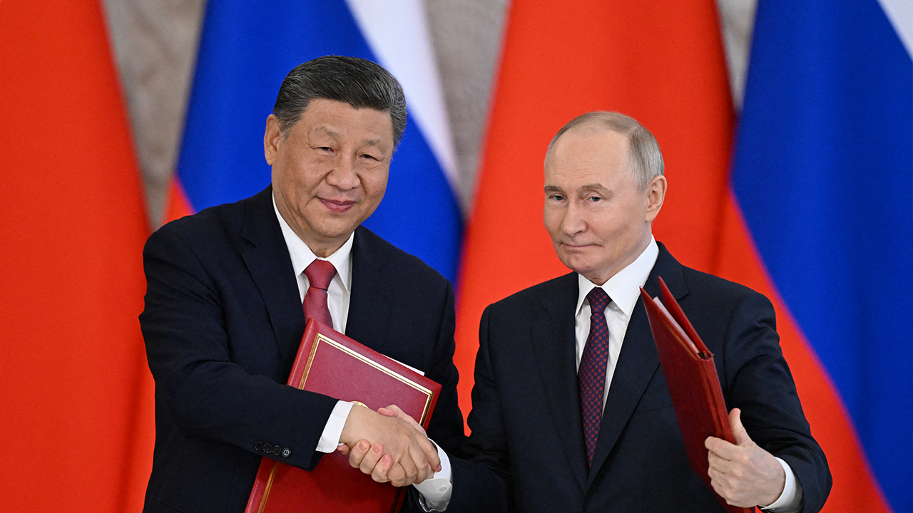 Russian President Vladimir Putin and his Chinese counterpart Xi Jinping exchange documents during a signing ceremony following their talks at the Kremlin in Moscow on May 8, 2025. (Photo by Kirill KUDRYAVTSEV / AFP) (Photo by KIRILL KUDRYAVTSEV/AFP via Getty Images) (Photo by KIRILL KUDRYAVTSEV/AFP via Getty Images)