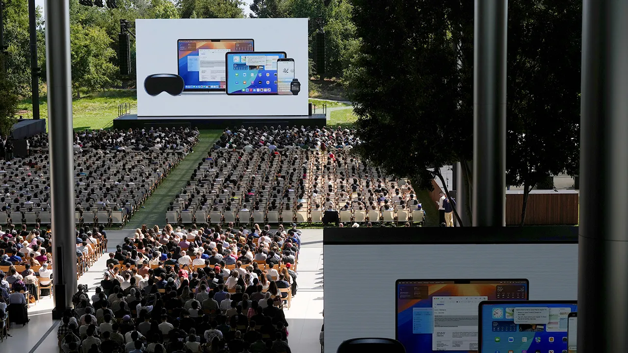 Attendees watch a presentation during an event on the Apple campus in Cupertino, Calif., Monday, June 9, 2025. (AP Photo/Jeff Chiu)