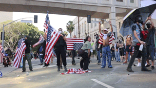 Protesters in Los Angeles seen taunting camera and waving American flags