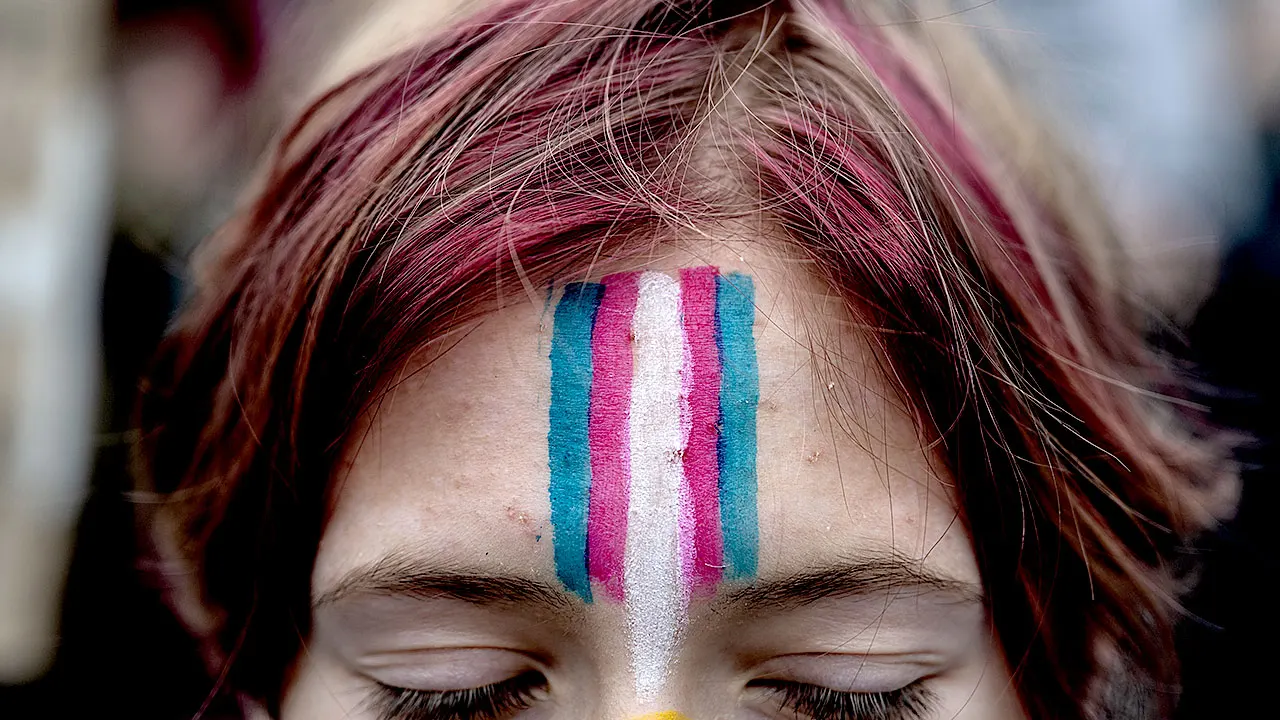 A demonstrator with a face painting of the trans flag during the Rise Up for Trans Youth rally against President Donald Trump's executive actions targeting transgender people at Union Square in New York, US, on Saturday, Feb. 7, 2025. (Getty Images)