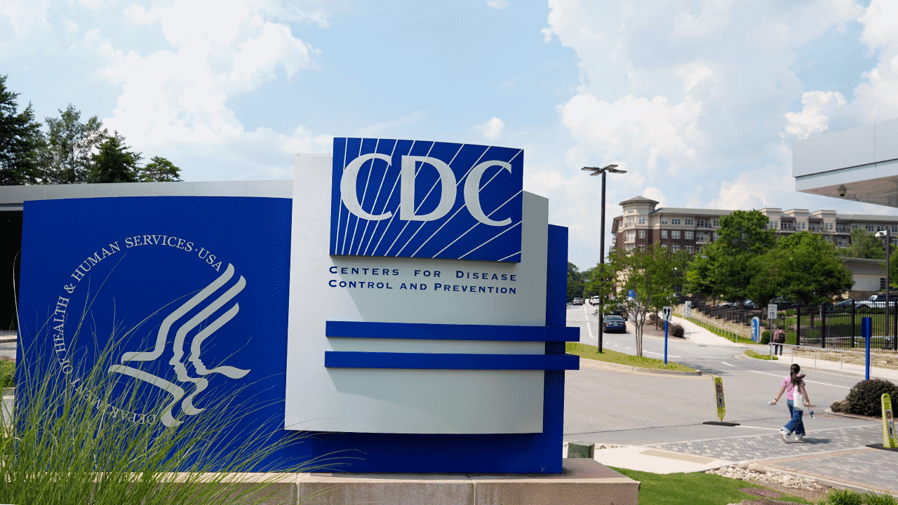 CDC sign with someone walking in the background