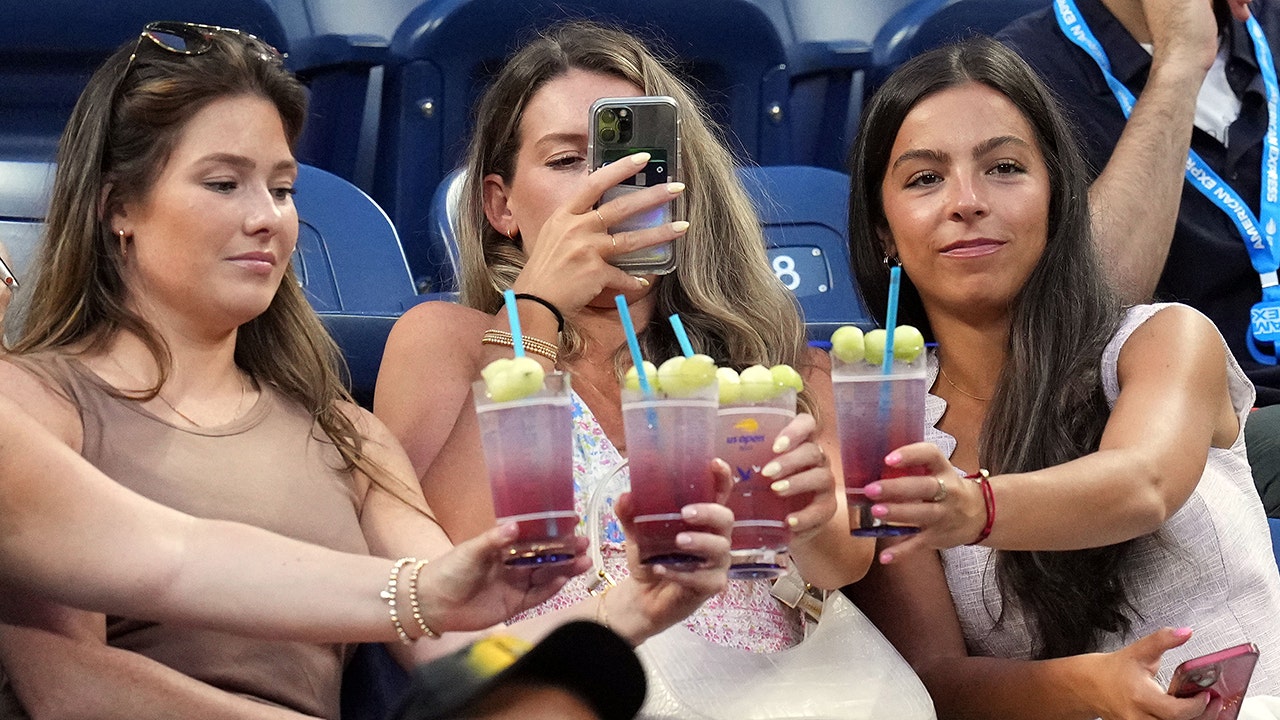 Fans take a photo of their Honey Deuce cocktails at the U.S. Open. (USA TODAY Sports via Reuters Connect)