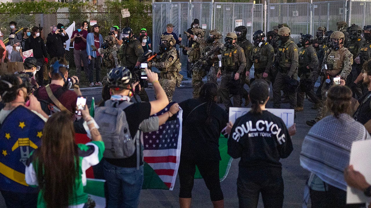 Federal law enforcement agents confront demonstrators protesting outside an immigrant processing center on Saturday in Broadview, Illinois. One protester allegedly threatened to kill federal officers. (Getty Images)