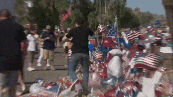 A man wearing what appeared to be the same shirt as the suspected assassin of Turning Point USA founder Charlie Kirk disrupted a makeshift memorial outside the organization’s Phoenix headquarters on Sunday.