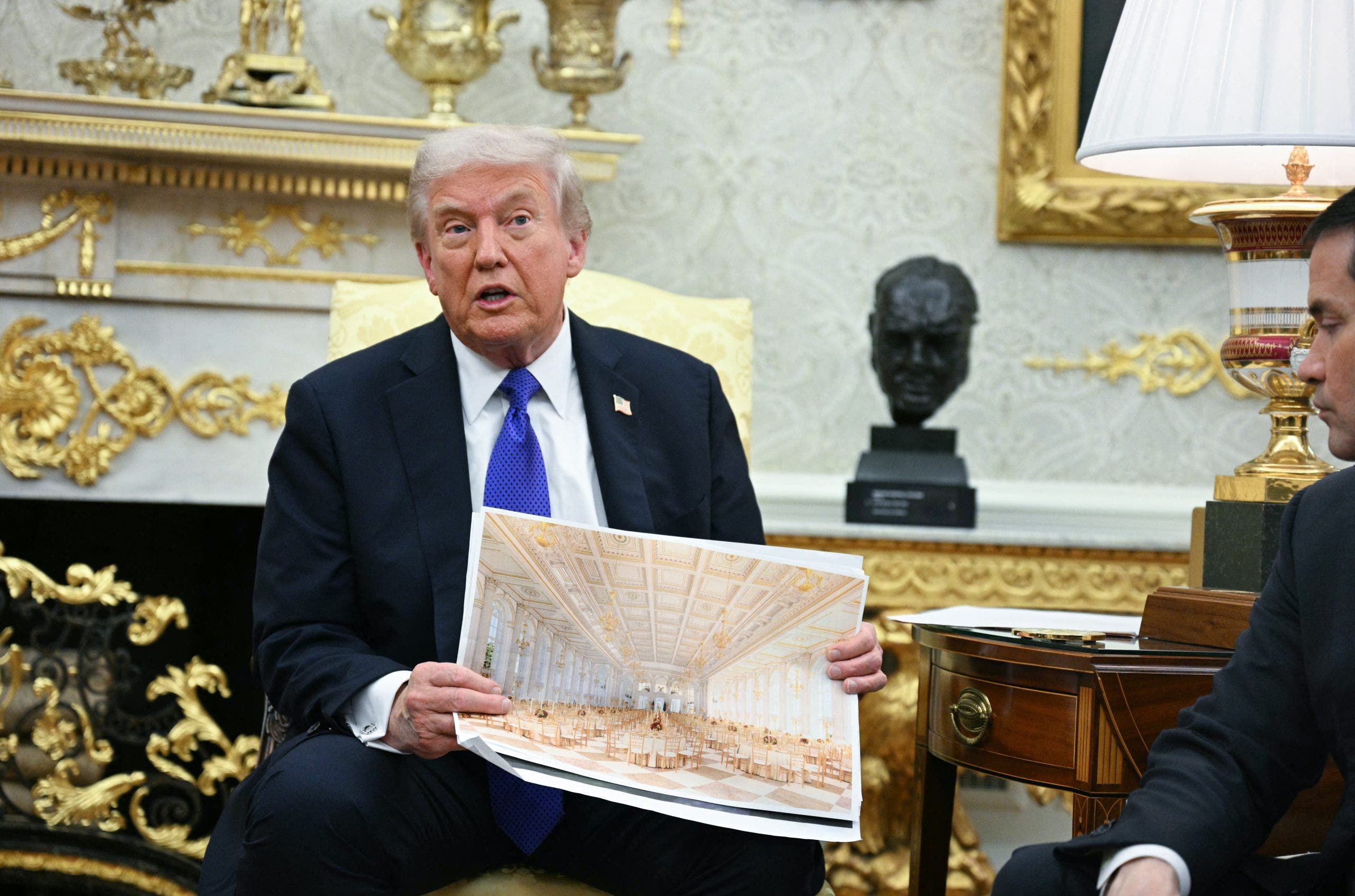President Donald Trump shows an image of his planned ballroom as he meets with NATO Secretary General Mark Rutte in the Oval Office of the White House in Washington, D.C., on Oct. 22, 2025. (Jim Watson/AFP via Getty Images)