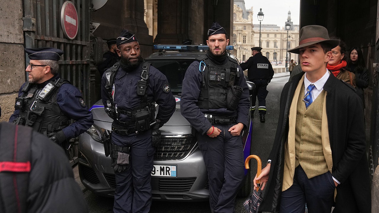 Mystery man in dapper suit goes viral after appearing in Louvre heist investigation photo Mystery man in dapper suit goes viral after appearing in Louvre heist investigation photo