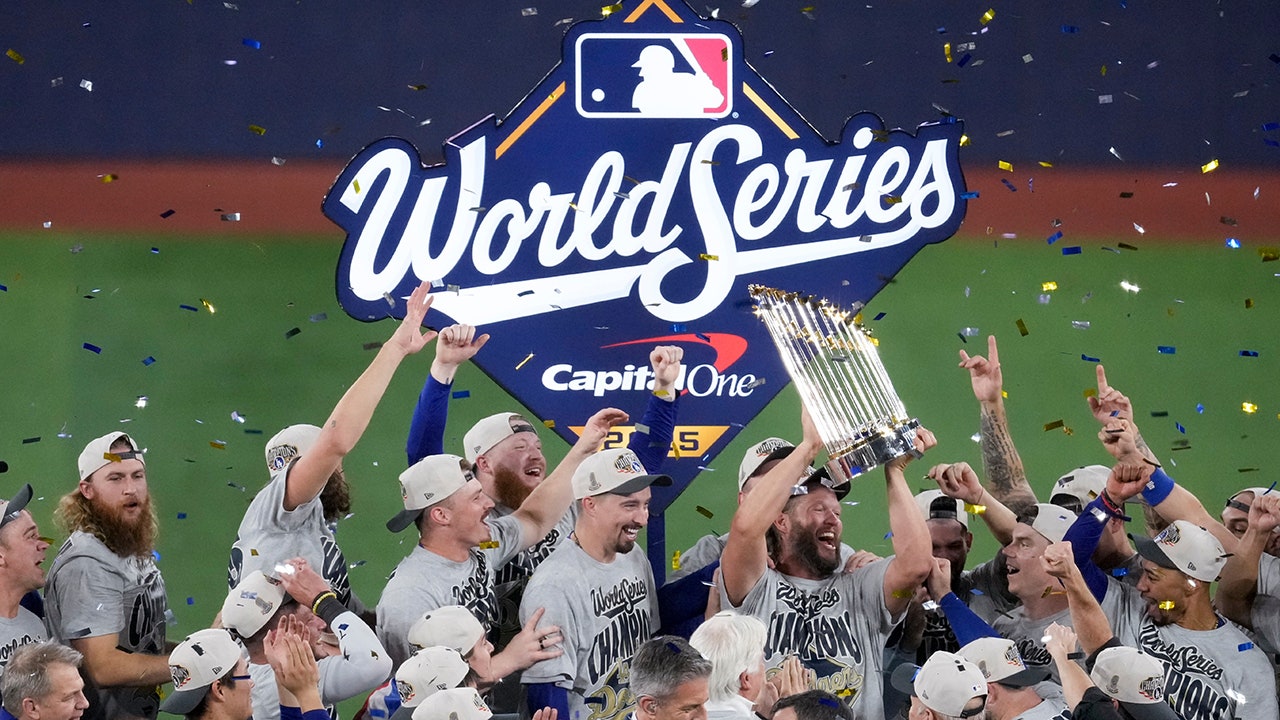 Los Angeles Dodgers star Clayton Kershaw holds the trophy as the Dodgers celebrate their win in Game 7 of baseball's World Series against the Toronto Blue Jays, Sunday, Nov. 2, 2025, in Toronto. (AP Photo/Ashley Landis)